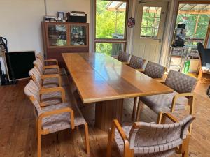 a large wooden table and chairs in a room at マキノ山荘 貸別荘 アメリカンロッジ in Takashima
