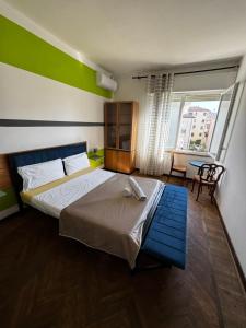 a bedroom with a bed and a large window at 3 minutes from train in Venice
