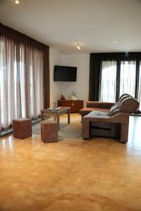 a living room with a couch and a tv at Hotel Rural O Salazón in Cambados