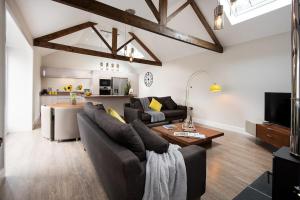 a living room with a couch and a table at The Stables at West Lyham in Chatton