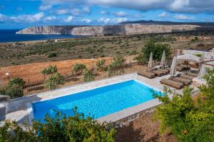 a swimming pool with a view of the ocean at Anemos Suites Mani in Gerolimenas +48 photos