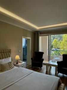 a bedroom with a bed and a large window at Vila Park Hotel 1 in Tirana +26 photos