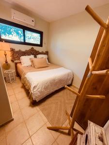 a bedroom with a bed and a staircase in it at אירוח בעמק in Yesod Hamaala