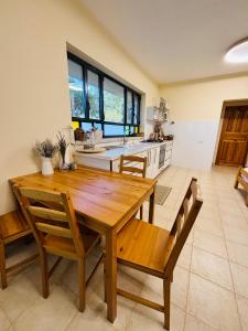 a large kitchen with a wooden table and chairs at אירוח בעמק in Yesod Hamaala