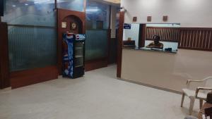 a lobby with a counter and a soda machine at Hotel Swaagat in Agra