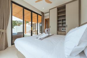 a bedroom with a large white bed and large windows at Staylar Sunrise Villas - Chaweng Noi, Koh Samui in Amphoe Koh Samui +133 photos