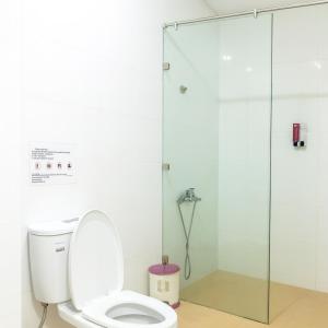 a bathroom with a toilet and a glass shower stall at Du Thuyền 2 Hotel Hồ Chí Minh in Ho Chi Minh City