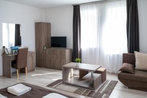 a living room with a couch and a table at F&M Apartman in Egerszalók