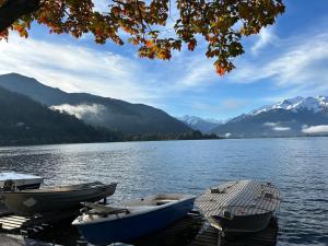 three boats are docked on a dock on a lake at Appartment Marcher in Kaprun +8 photos