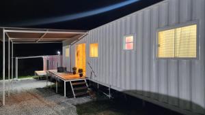 a house with a table in front of it at Casa Container Branca in Bagé