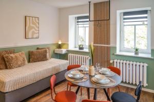 a living room with a couch and a table with chairs at BaLa Suites Apartment House in Bad Lausick