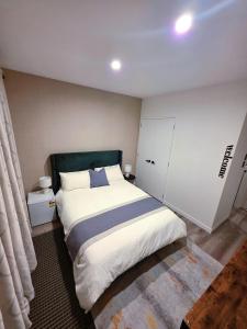 a bedroom with a large white bed in a room at Long Bay Breeze Ensuite in Auckland
