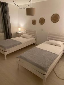 two twin beds in a room with at Apartman Turić Vinkovci in Vinkovci