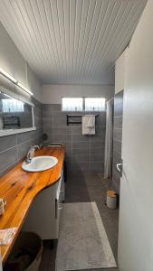 a bathroom with a sink and a wooden counter at Ajoupa Dielcane in Lamentin +31 photos