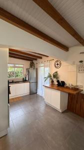 a kitchen with a refrigerator and a counter top at Ajoupa Dielcane in Lamentin