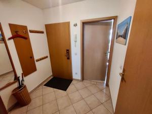 a hallway with two doors and a tile floor at Seemöwe in Binz