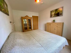 a bedroom with a large bed and a dresser at Seemöwe in Binz