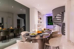 a dining room with a table and chairs at Plaka Villa with Epic Acropolis Views in Athens