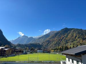 a view of a mountain range with a soccer field at Appartment Marcher in Kaprun
