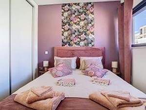 a bedroom with a large bed with pillows on it at Casa Launa Fuseta in Fuzeta +29 photos