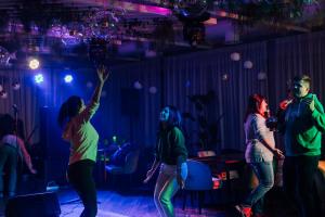 a group of people dancing in a room with lights at SPA Hotel Galera in Kyiv +68 photos