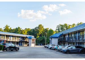 a row of cars parked in front of a building at Budget Inn Greenville By Hotel O I-85 in Greenville