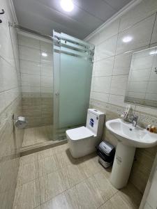a bathroom with a toilet and a sink and a shower at Old Saroy Hotel in Samarkand