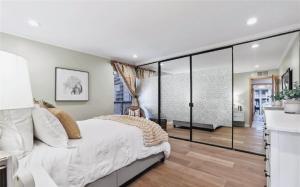 a bedroom with a large bed and glass walls at Waterfront Three-Bedroom Condo with Great Views in Naples +3 photos