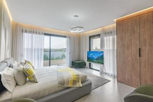 a bedroom with a large bed and a large window at Villa Sofya - Roche Bobois Design & HD Wifi in Marrakesh