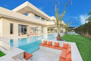 a villa with a swimming pool and a house at Villa Sofya - Roche Bobois Design & HD Wifi in Marrakesh