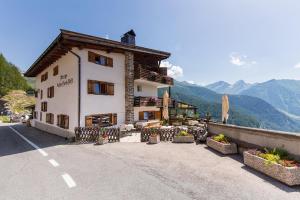 a large building on the side of a road at Hochfirst in Corvara in Passiria