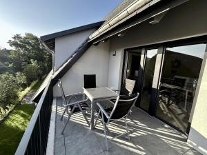 a patio with a table and chairs on a balcony at WeberHof Appartements in Burg +9 photos