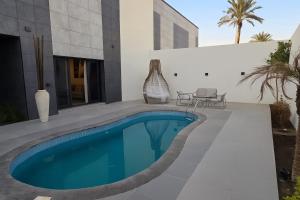 a swimming pool in the backyard of a house at Al- Abasly Suites in Baghdād