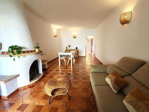 a living room with a couch and a fireplace at 61 Casa Pitta Manau - Casas & Papéis in Porches