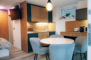 a small kitchen with a table and chairs in a room at Rooms Kozarje in Ljubljana