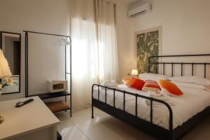 a bedroom with a bed with orange pillows and a desk at Villa Vera in Salerno