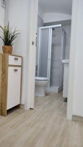 a bathroom with a toilet and a shower and a sink at Roca House in Valenzano