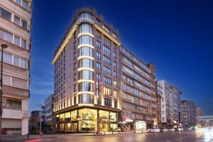 a tall building on a city street at night at Bentley Hotel Bosphorus - Special Class in Istanbul
