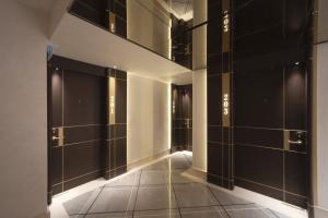 a hallway with black doors and a tile floor at Bentley Hotel Bosphorus - Special Class in Istanbul