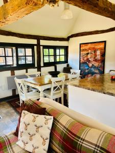 a living room with a couch and a table at The Thatched Barn in Thame