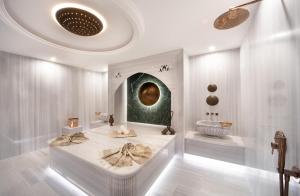 a white room with a bed and a tub in it at Bentley Hotel Bosphorus - Special Class in Istanbul +7 photos