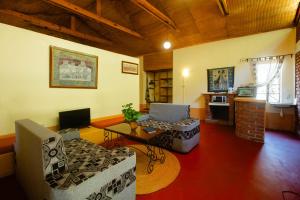 a living room with a couch and a table at Octagon Lodge in Karatu