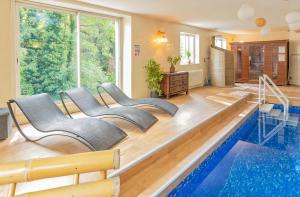 a room with a pool with chairs and a swimming pool at La Maison Mori in Vienne