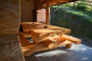 a wooden table sitting on a patio under a porch at Cabana Cristi in Vatra Dornei