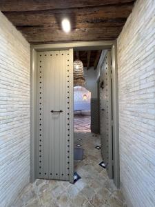 a hallway with three stalls in a room with a bed at Traditional Aicha House in Tozeur +3 photos