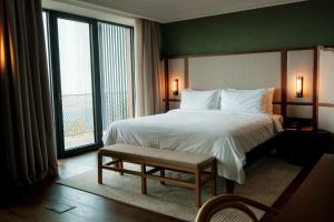 Postel nebo postele na pokoji v ubytování BODBE Hotel