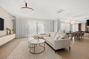 a living room with a couch and a table at Luxury Villa del Sol in Premantura