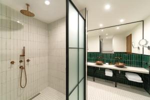 a bathroom with two sinks and a shower at BODBE Hotel in Sighnaghi