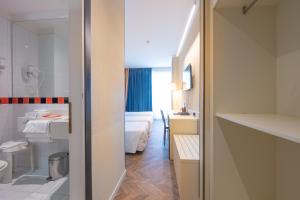 a hotel room with a bathroom with a bed at Admiral Art Hotel in Rimini +68 photos