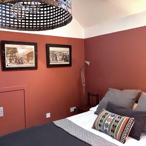 a bedroom with a bed and two pictures on the wall at Raven Cottage in Rhiconich